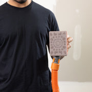 Close-up of Full Circle MINI mesh abrasive sheet on sander showing diamond cutting edges and open mesh grit texture