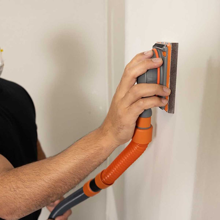 Contractor using Mini Flex Air detail sander with vacuum hose for dust-free corner sanding