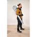 Worker carrying Mirka DecoSander in its shoulder carrying case — lightweight portable sander kit