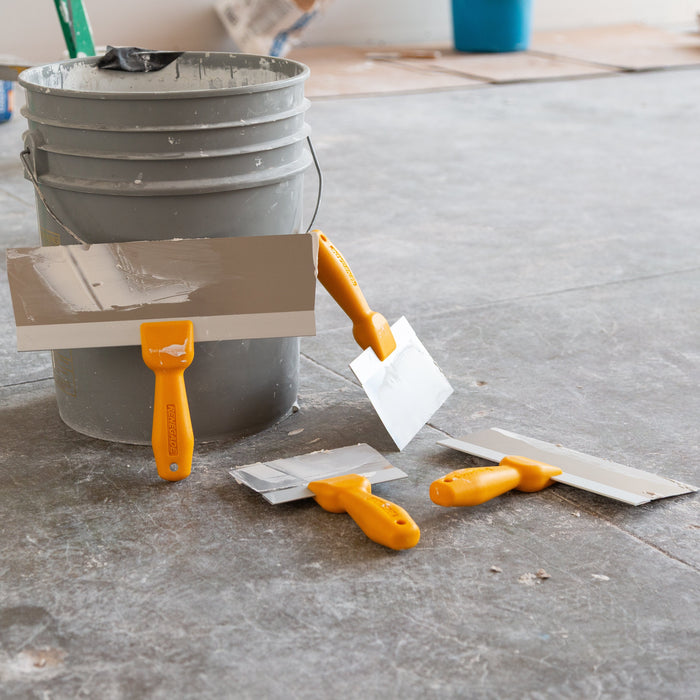 Professional Renegade textured handle drywall taping knives on active drywall finishing jobsite