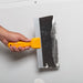 Renegade blue steel drywall taping knife smoothing joint compound on drywall seams