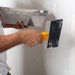 Renegade mud pan and blue steel taping knife applying joint compound to drywall seams