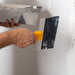 Renegade mud pan and blue steel taping knife applying joint compound to drywall seams