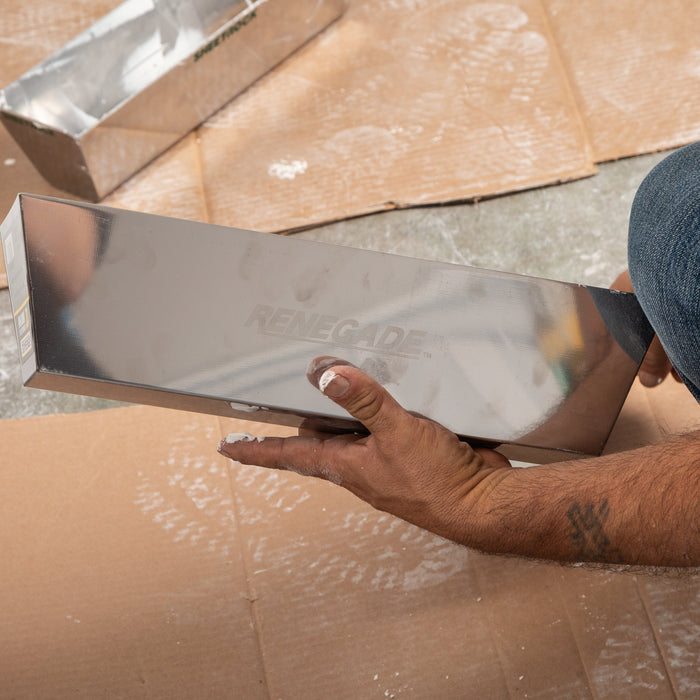 Renegade stainless steel drywall mud pan with blue steel taping knife on jobsite