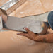 Renegade stainless steel drywall mud pan with blue steel taping knife on jobsite