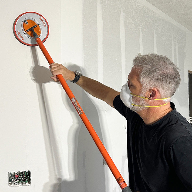 Drywall contractor sanding wall using Full Circle Radius360 sander with pole attachment