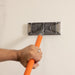 Flex Edge 2.0 used horizontally by professional to sand large wall surface with foam/rubber pad finish