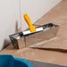 Renegade drywall mud pan with blue steel taping knife and joint compound on jobsite